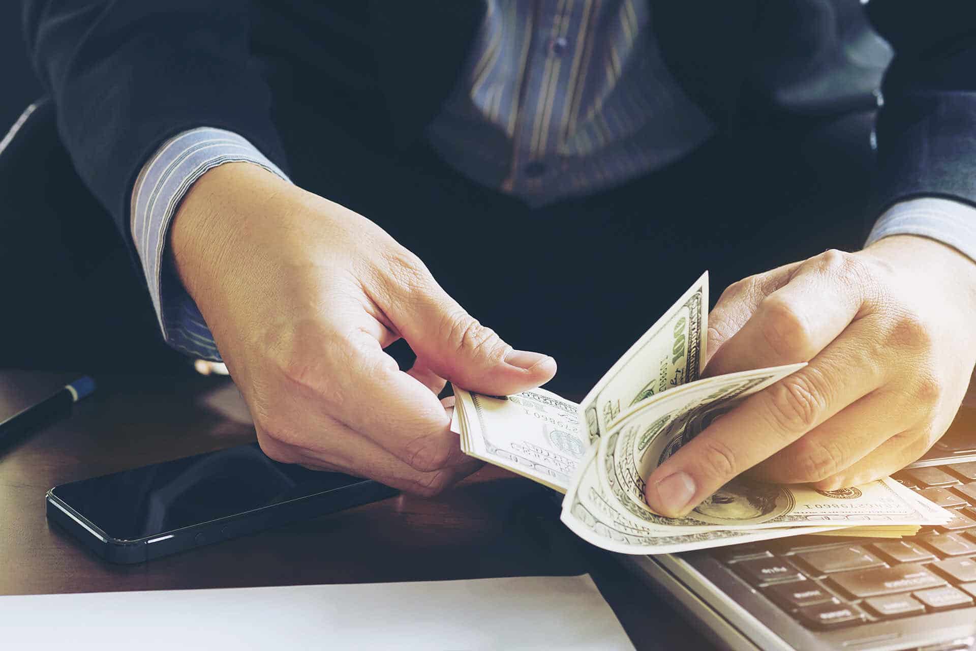 Businessman Counting Dollars